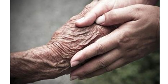 jongere hand pakt oudere hand vast