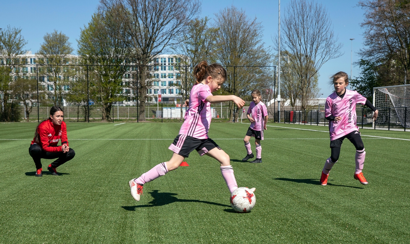 Lotte geeft voetbaltraining aan jonge meiden